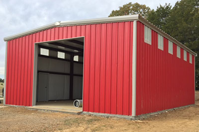 Red Iron Metal Shop garage with large bay door